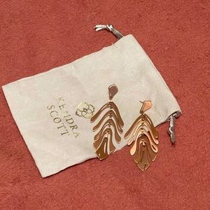 Rose gold Kendra Scott palm leaf earrings.